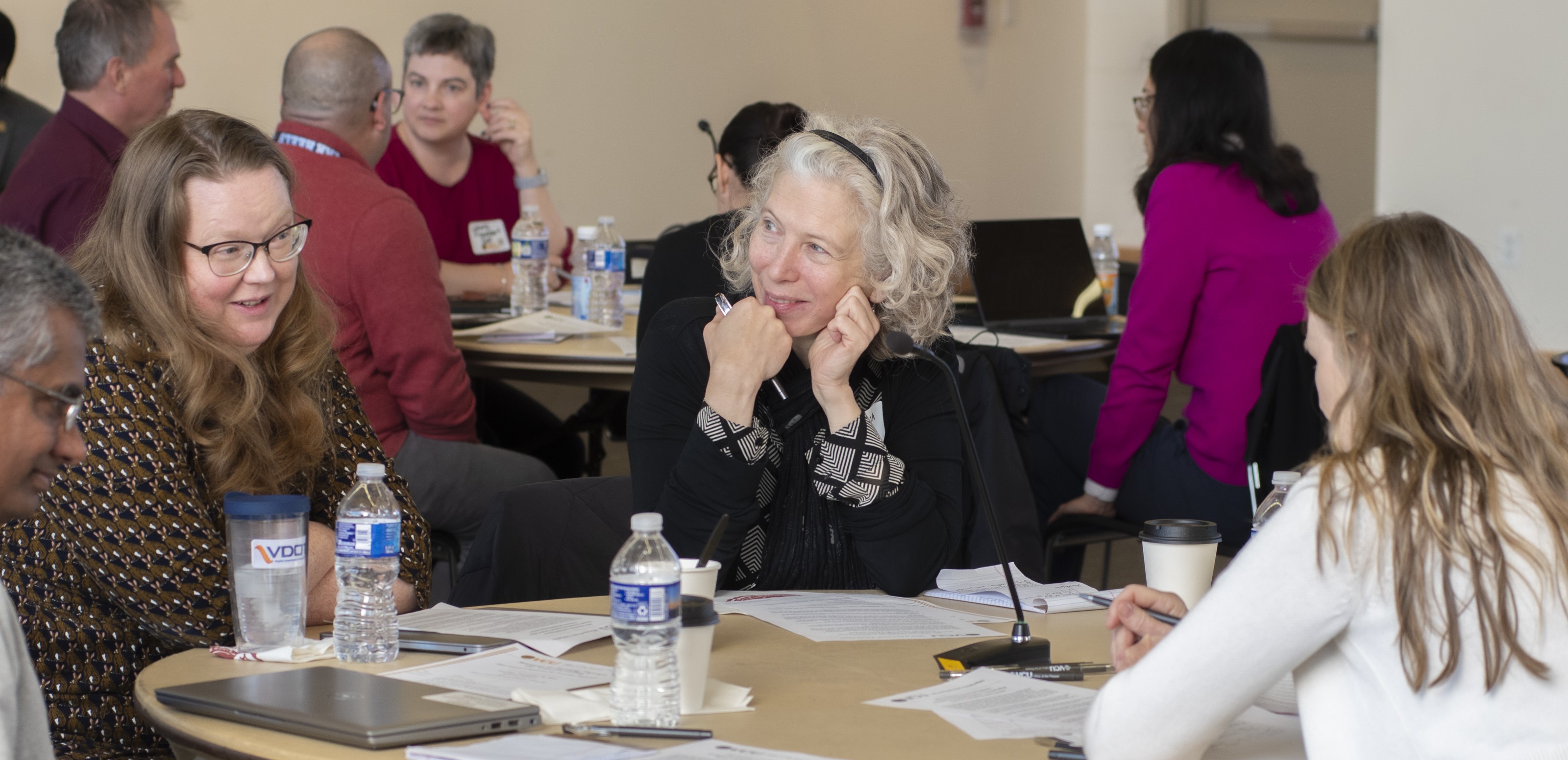 Image of faculty members talking at a table