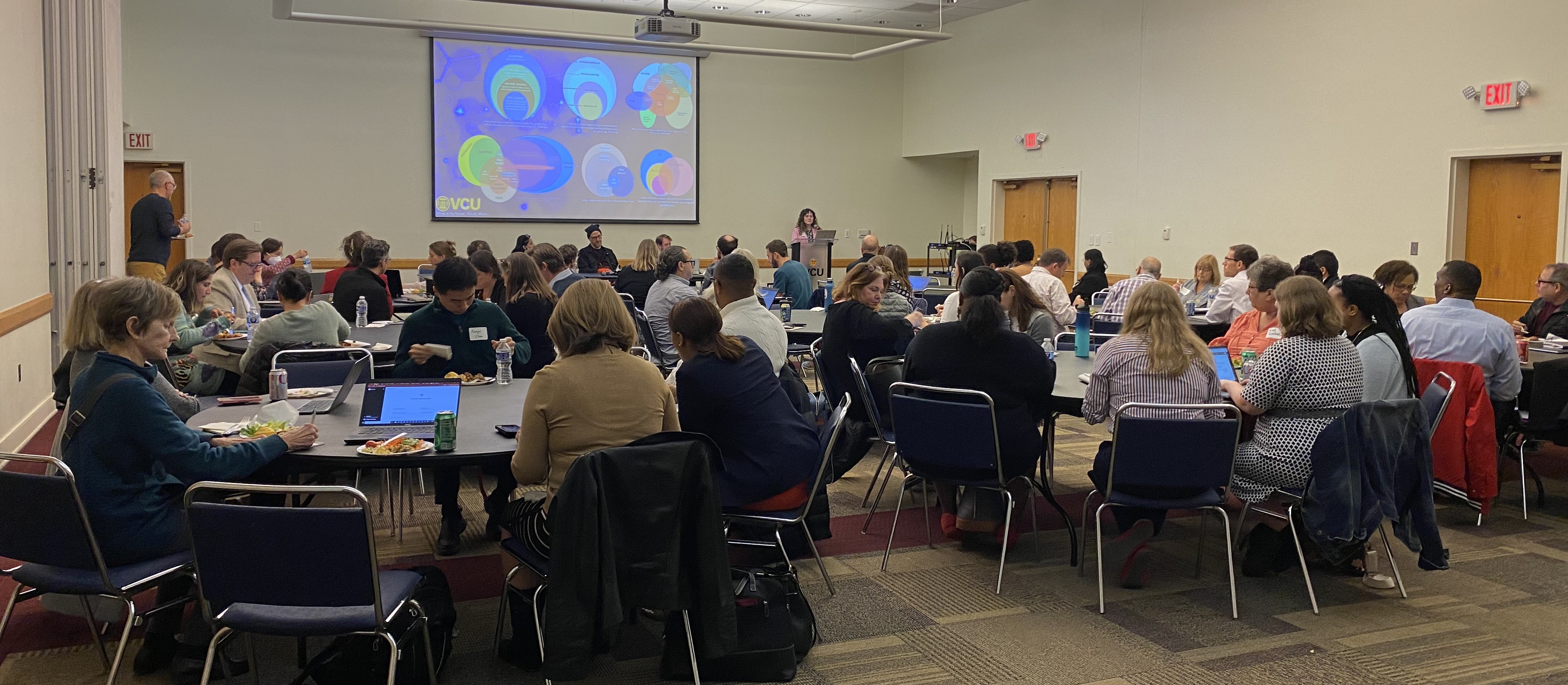 Image of faculty members sitting at tables attending a development session.